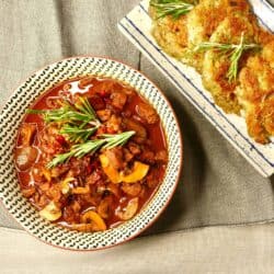 vegan German style goulash with soy protein chunks served with potato fritters