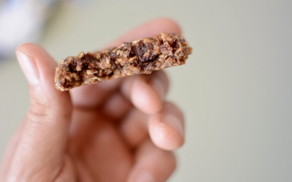 Photo of a bitten oatmeal cookie, showing the insides