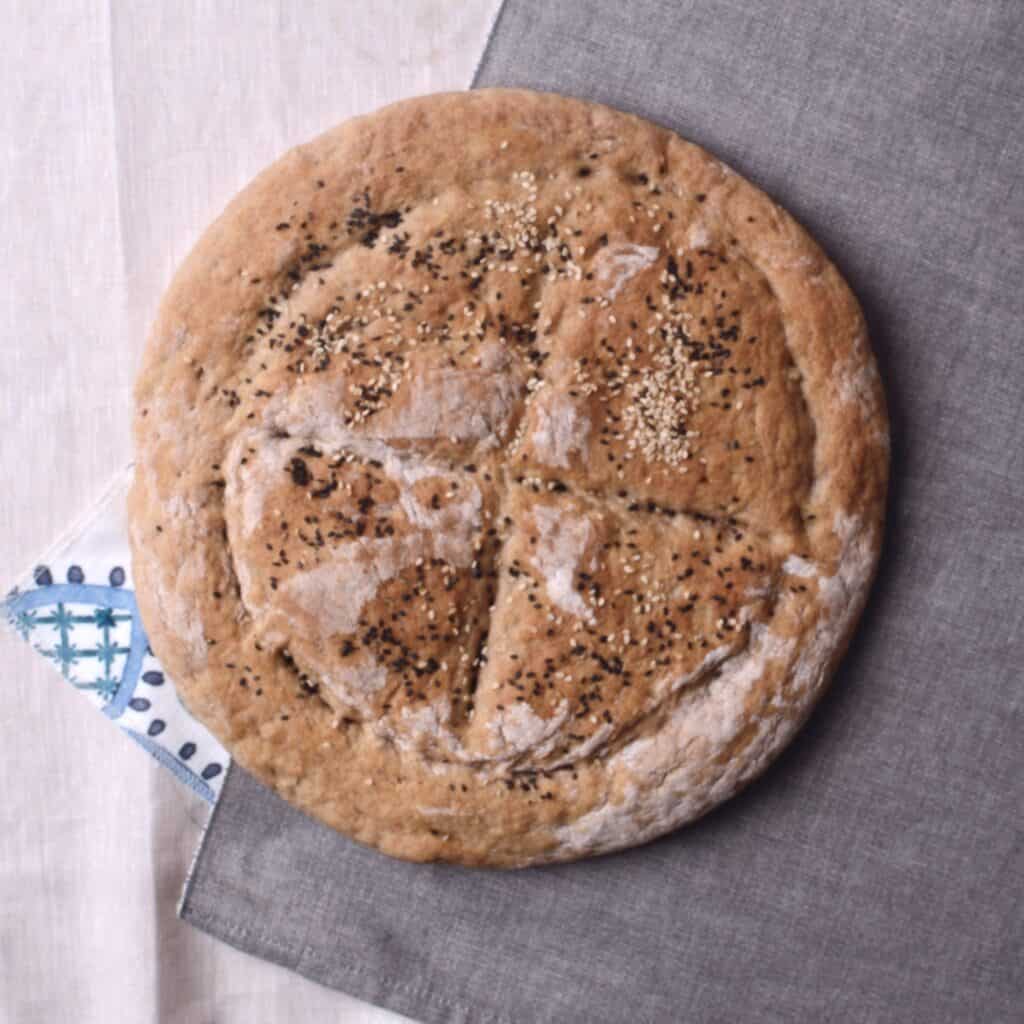 a home baked pide bread laying on sheets.