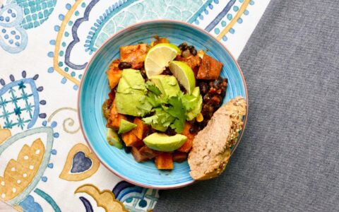 a plate of black bean and sweet potato chili with avocado
